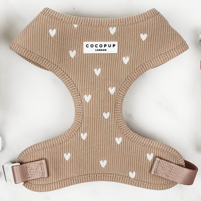 Beige ribbed dog harness with white hearts and a center Cocopup London label.