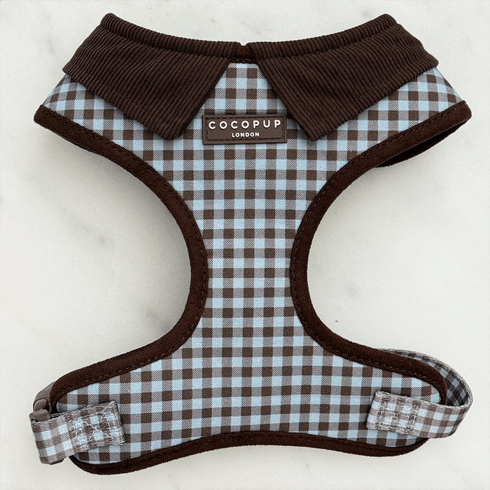 A brown and blue check print dog harness. With brown hardware and brown corduroy collar detail.