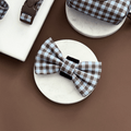 A brown and blue check print bow tie for dogs. With velcro fastening.