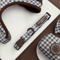 A brown and blue check print dog collar. With brown hardware.