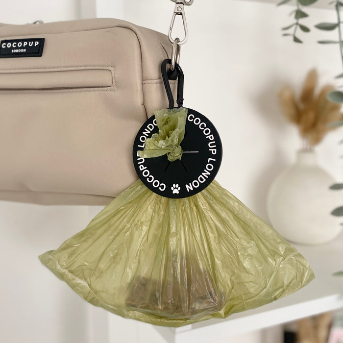 Black Cocopup London CocoPOOP Pocket holding green dog waste bags, compact and hands-free for walks.