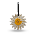 Daisy-shaped poop bag holder with yellow center and black hook, from Cocopup London.