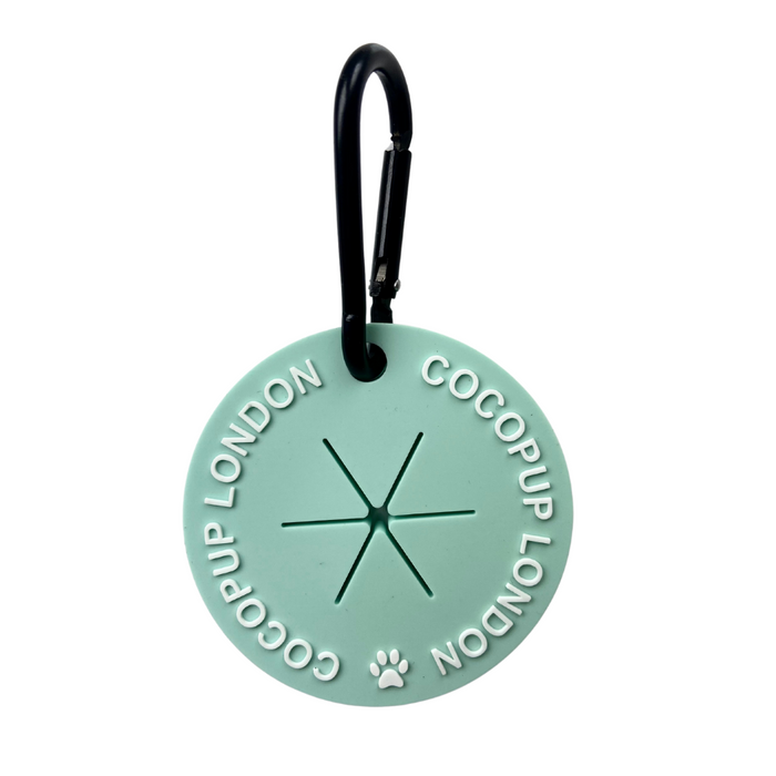 Mint green CocoPOOP Pocket with round paw print tag, black carabiner, and Cocopup London charm.
