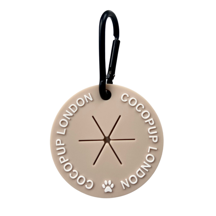Nude waste bag holder with black carabiner and subtle paw print, from Cocopup London.