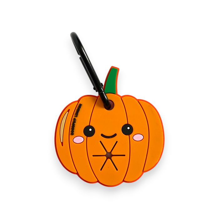 Orange pumpkin-shaped keychain with a smiling face, made of soft material and silver clip.