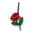 Red rose-shaped keychain pouch with gold hardware, designed for carrying dog waste bags.