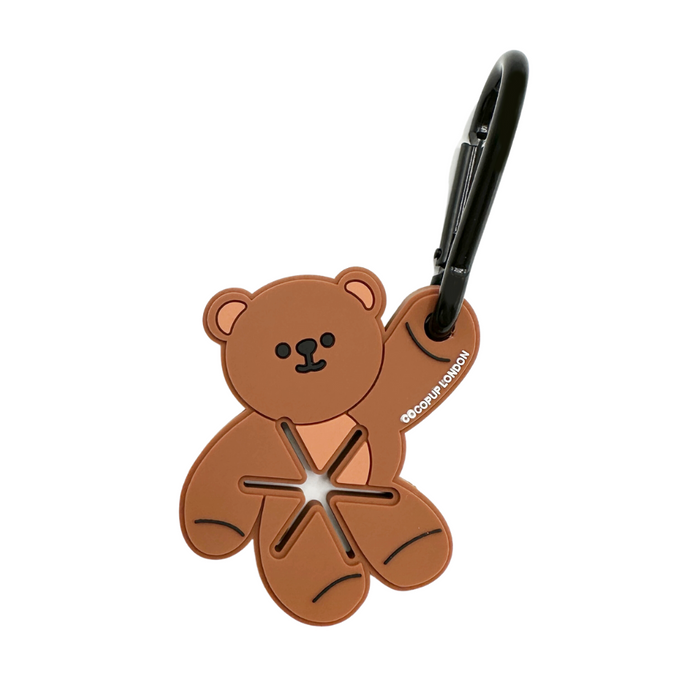 Brown teddy bear-shaped bag charm and poop bag holder with soft, plush texture from Cocopup London.