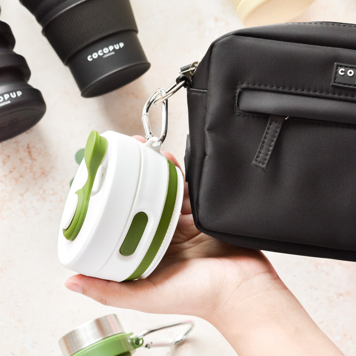 Plain Khaki with White Lid Collapsible Silicone Travel Coffee Cup attached to the Cocopup Dog Walking Bag via carabiner clip.