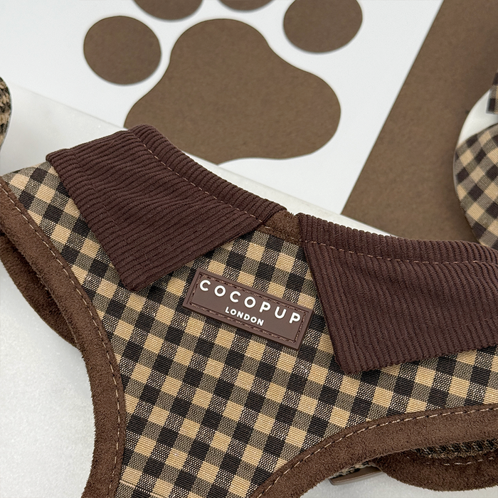Cotswold Check harness, lead, and collar set in beige plaid next to a black paw print design.