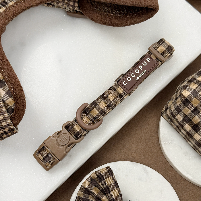 Cotswold Check harness, lead, and collar bundle in neutral plaid on a white surface with matching dog accessories.