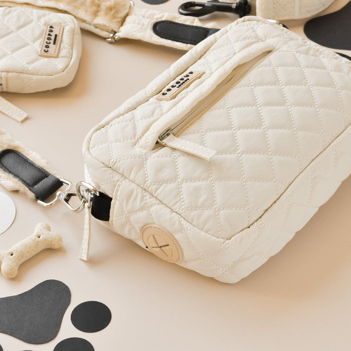 Cream quilted dog walking bag bundle with zipper, matching leash, treat pouch, and black paw print accents.