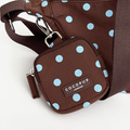 A brown fabric treat pouch with a light blue polka dot pattern. Featuring Cocopup London logo badge and plain brown strap.