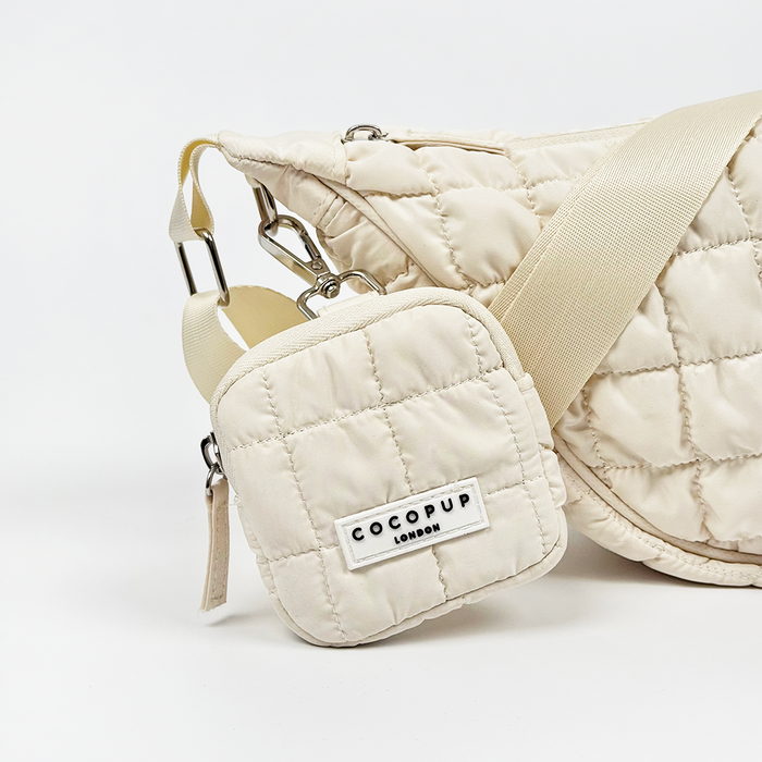 Cloud-colored crescent treat pouch with a front label and a detachable square coin pouch by Cocopup London.