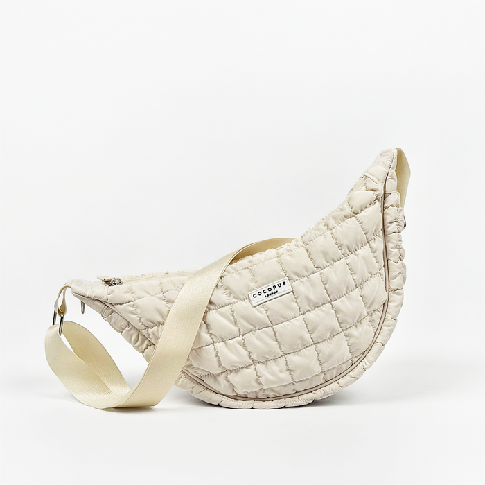 Quilted light grey crossbody dog walking bag with wide strap and front Cocopup London label.
