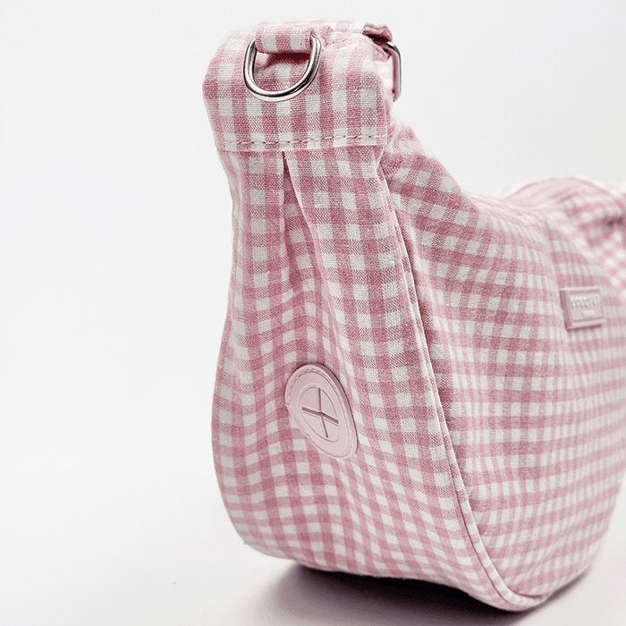 Poop bag dispenser on side of pink and white gingham check bag.