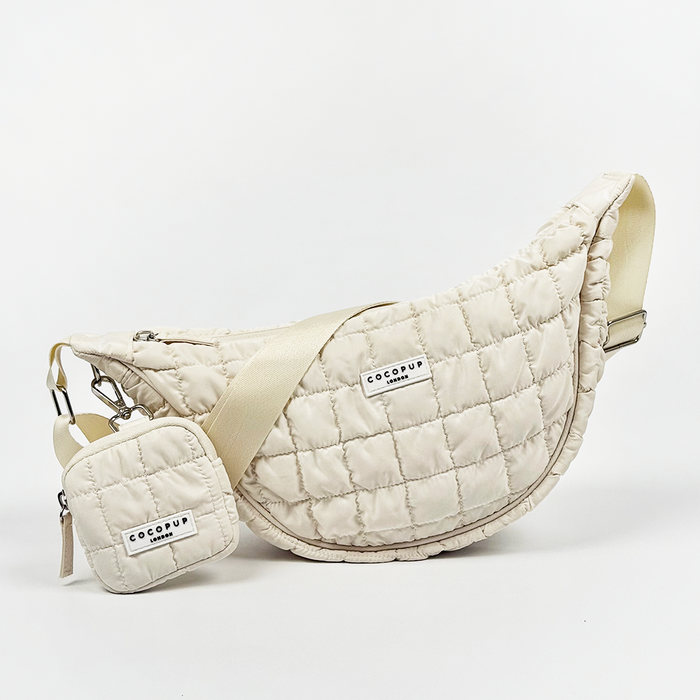 Light grey Cocopup London crescent crossbody dog walking bag with matching pouch attached.