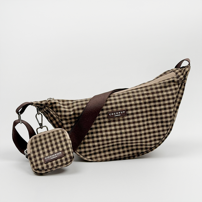 Cocopup London crossbody crescent bag in beige Cotswold check with matching pouch and poop bag dispenser.
