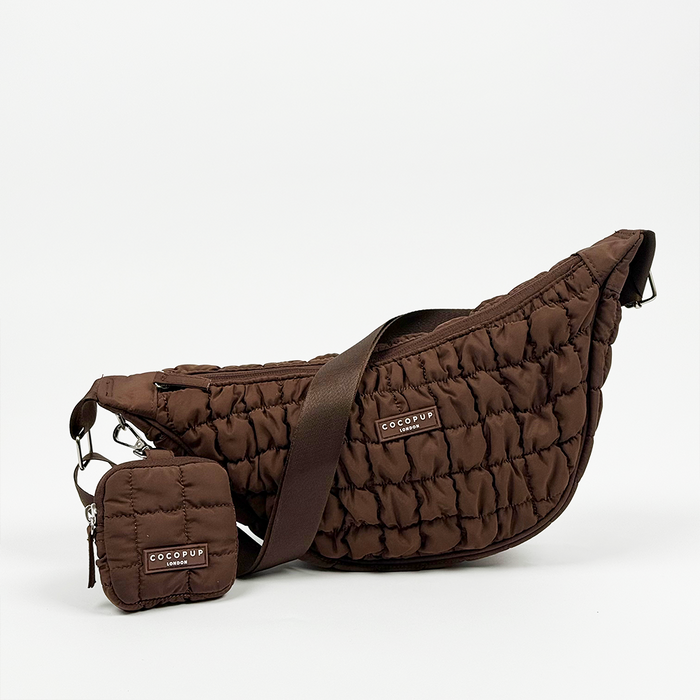Espresso brown crossbody crescent dog walking bag with matching pouch, both displayed on a white background.