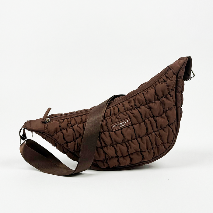 Brown crescent-shaped crossbody dog walking bag with adjustable strap, by Cocopup London.