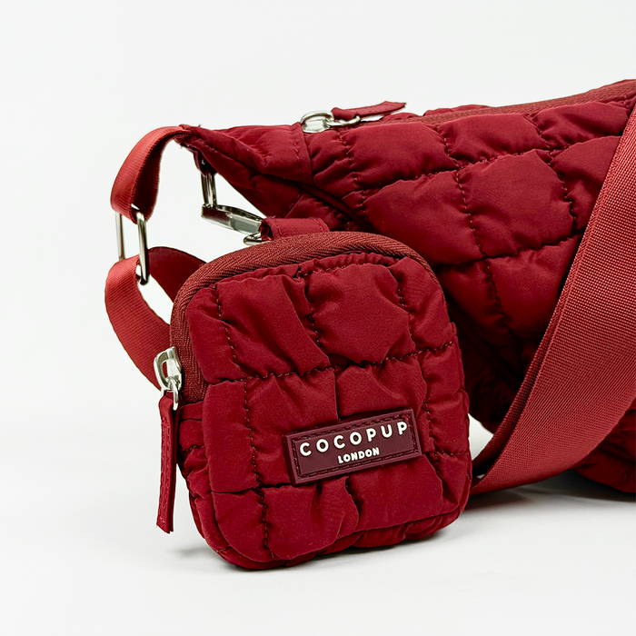 Merlot red Cocopup London crescent crossbody dog walking bag with matching coin purse and treat pouch attached.