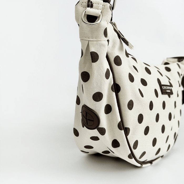 Polka dot handbag with a visible brand logo on a white background