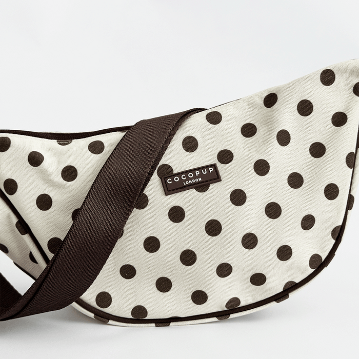 Polka dot pet carrier with 'CocoPup London' label on a white background