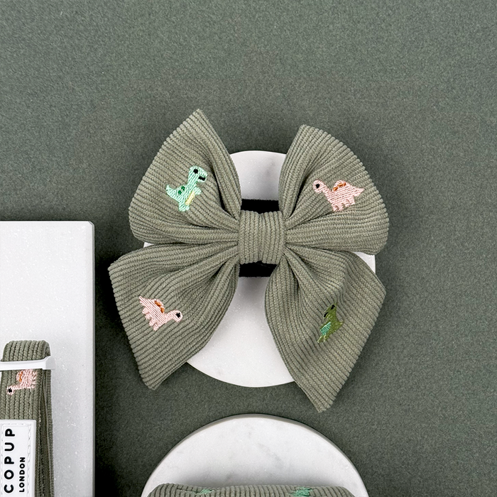 Green corduroy material Dog Sailor Bow Tie with embroidered dinosaurs.