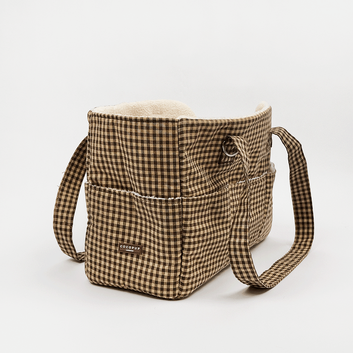 Brown check print Dog Carrier with a cream sherpa fleece lining, featuring a side pocket with white piping and rear pocket.