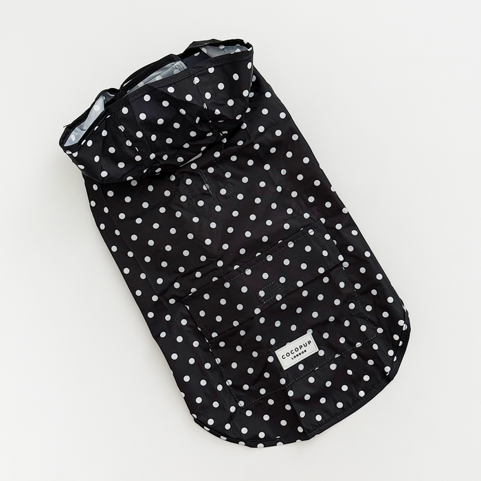 Black polka dot dog raincoat with hood and front pocket, lightweight and waterproof design.