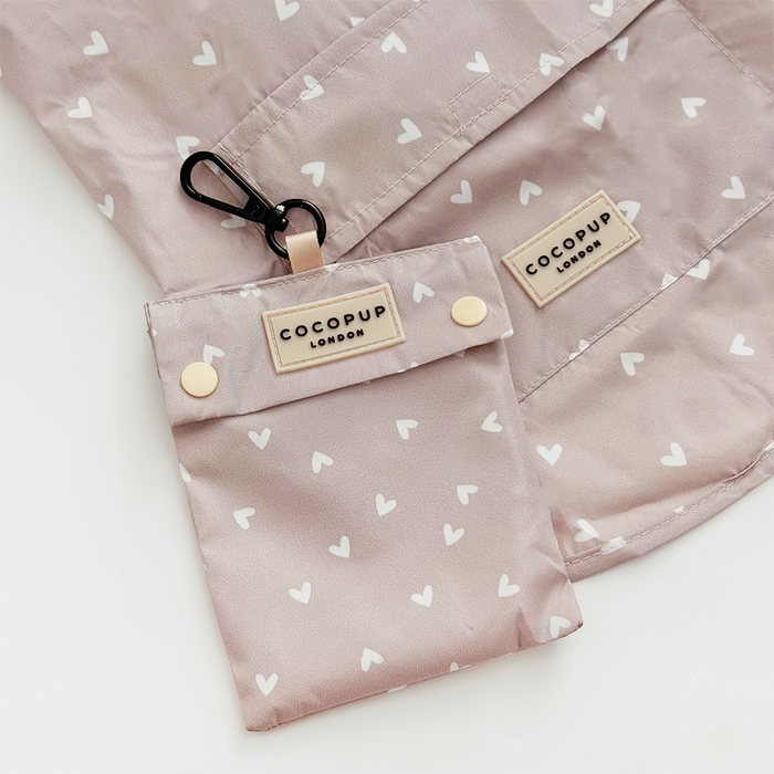 Light pink Cocopup London pouch with a white heart pattern.