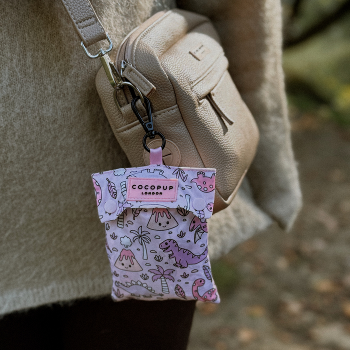 Small beige bag with a pink Cocopup London pouch, decorated with a Princess Dino graphic.