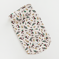 White Cocopup London dog raincoat with colorful bird and leaf print, features a pocket detail.
