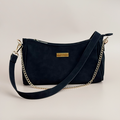 Black suedette Cocopup London dog walking bag with gold chain strap, logo plate, and built-in poop bag dispenser.