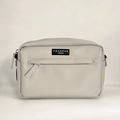 Caramel tan Cocopup London dog walking bag with front zipper, water-resistant finish, and a black logo patch.