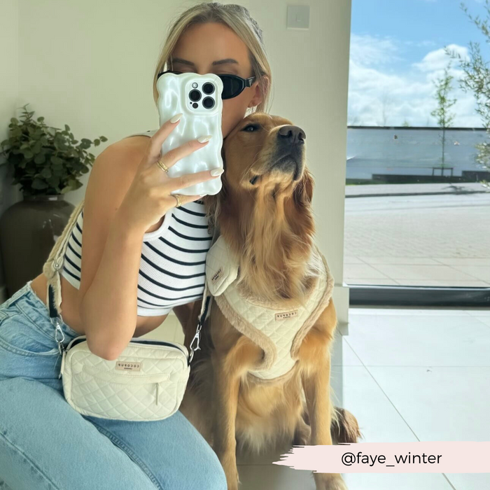 Woman in striped top and golden retriever in cream, with a cream quilted Cocopup London dog walking bag visible.