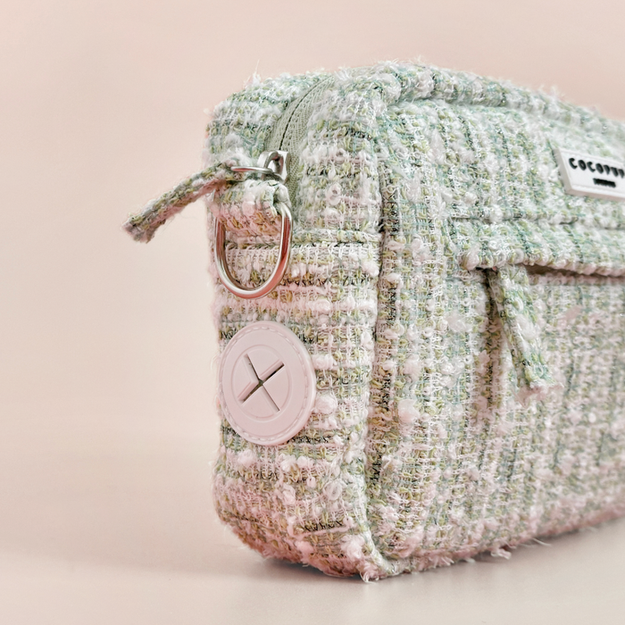 Cocopup London dog walking bag in matcha green textured tweed with zipper, metal ring, and button detailing.