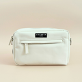 Oyster white dog walking bag by Cocopup London, small rectangular pouch with zipper and logo label on a plain background.