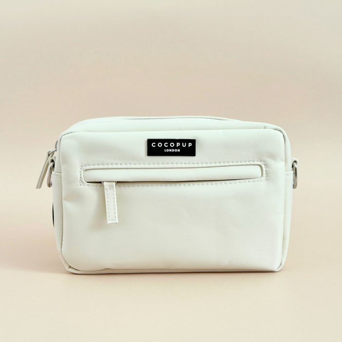 Oyster white dog walking bag by Cocopup London, small rectangular pouch with zipper and logo label on a plain background.
