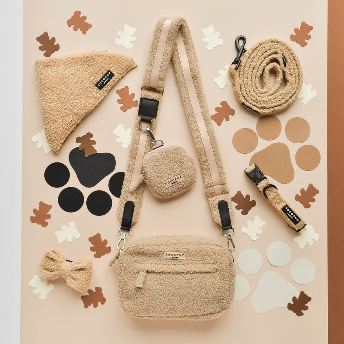 Beige dog walking bag, leash, collar, and treats with soft teddy material from Cocopup London displayed together.