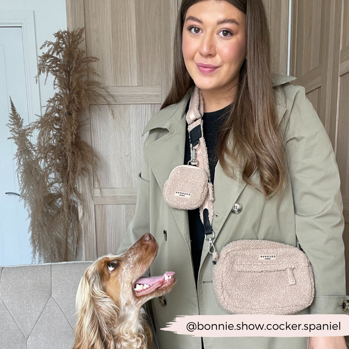 Woman in beige coat with spaniel, both matching with a tan Cocopup London Teddy Rupert dog walking bag.