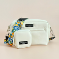 Yellow dog walking bag set with treat pouch, orange leaf-patterned strap, and matching poop bag dispenser.