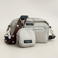 Beige Cocopup Dog Walking Bag, with small pouch for treats attached and also a brown bag strap with blue polka dots.