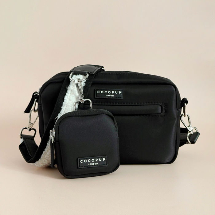 Black Cocopup London dog walking bag and matching treat pouch set on a beige background.