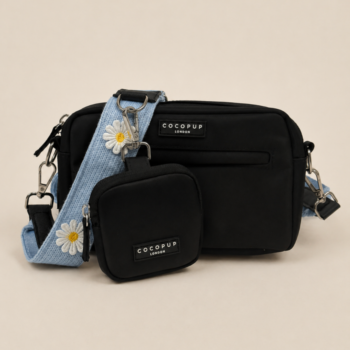 Black Cocopup Dog Walking bag, with blue Bag Strap attached with white flower decals. Also includes Cocopup Treat Pouch.