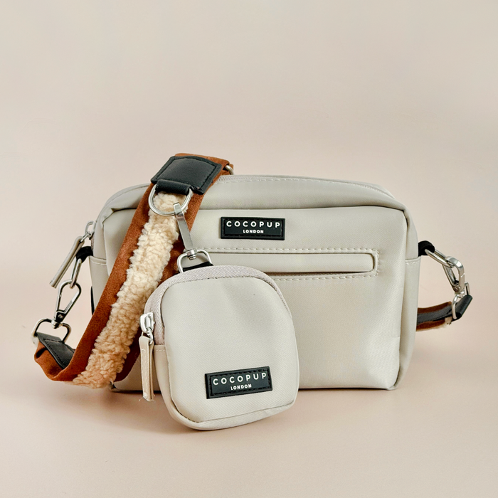 Two brown Cocopup London dog walking bags, one large and one small, both with cream straps.