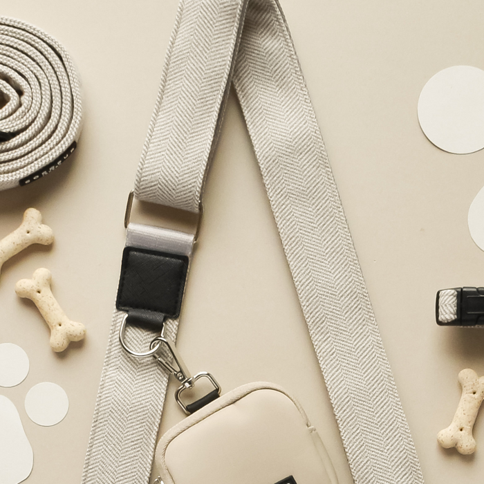Black Cocopup London dog walking bag, large size, shown with matching black leash, collar, treat pouch and poop bag holder.