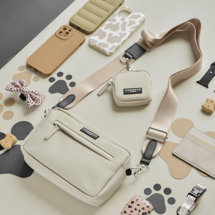 Cream-colored dog walking bag set with matching treat pouch, small pouch, and accessories in a caramel latte palette.