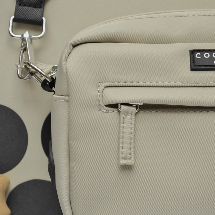 Caramel latte Cocopup London dog walking bag with zipper pocket and attached poop bag dispenser, shown close-up.