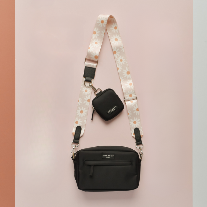 Cocopup London dog walking bag bundle with daisy chain pattern, matching treat pouch and daisy strap on a pink background.