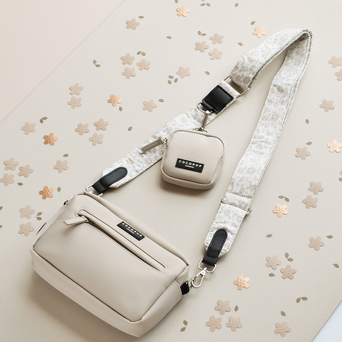 Garden Meadow dog walking bag with matching treat pouch and floral-patterned strap on a flower-print background.